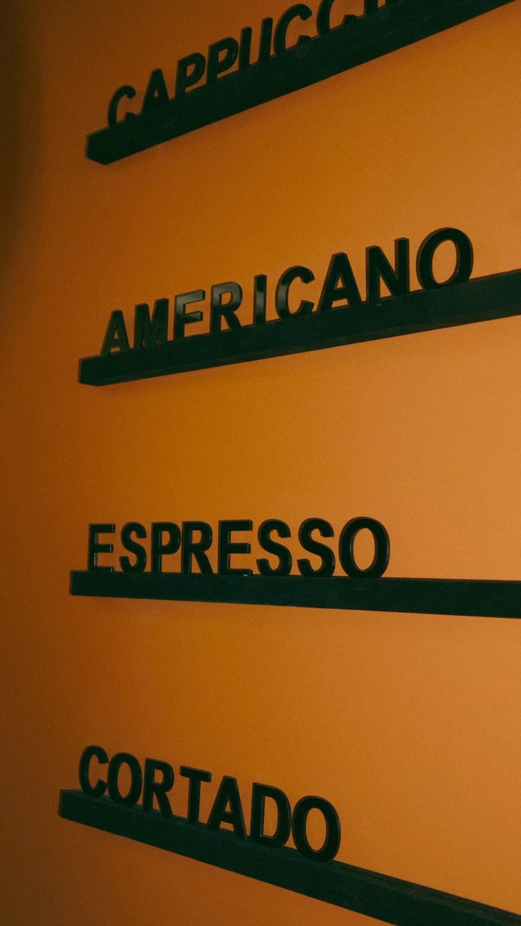 Chalkboard menu listing coffee drinks at Revival Coffee, Richardson Texas